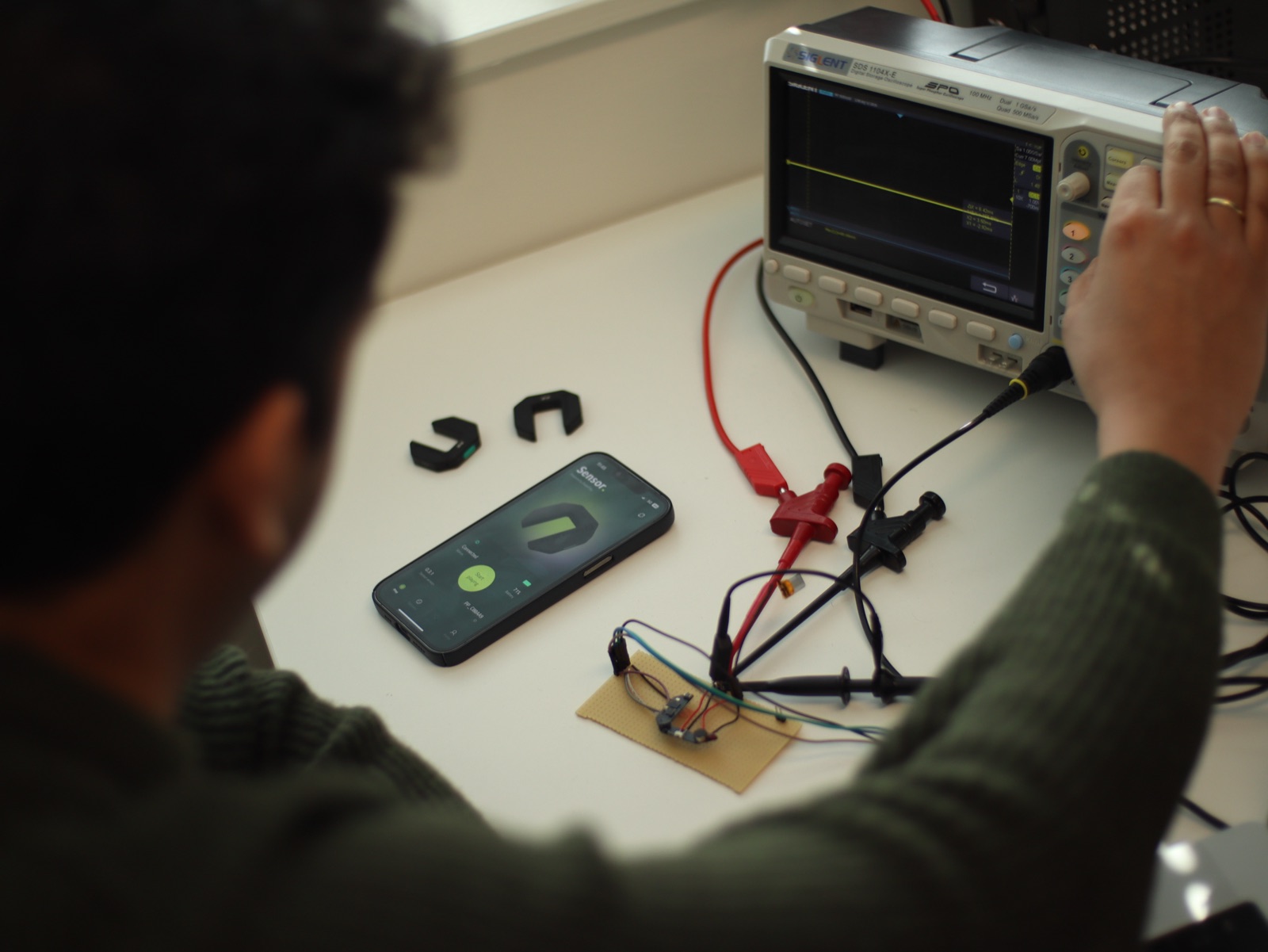 Engineer testing PCB with oscilloscope