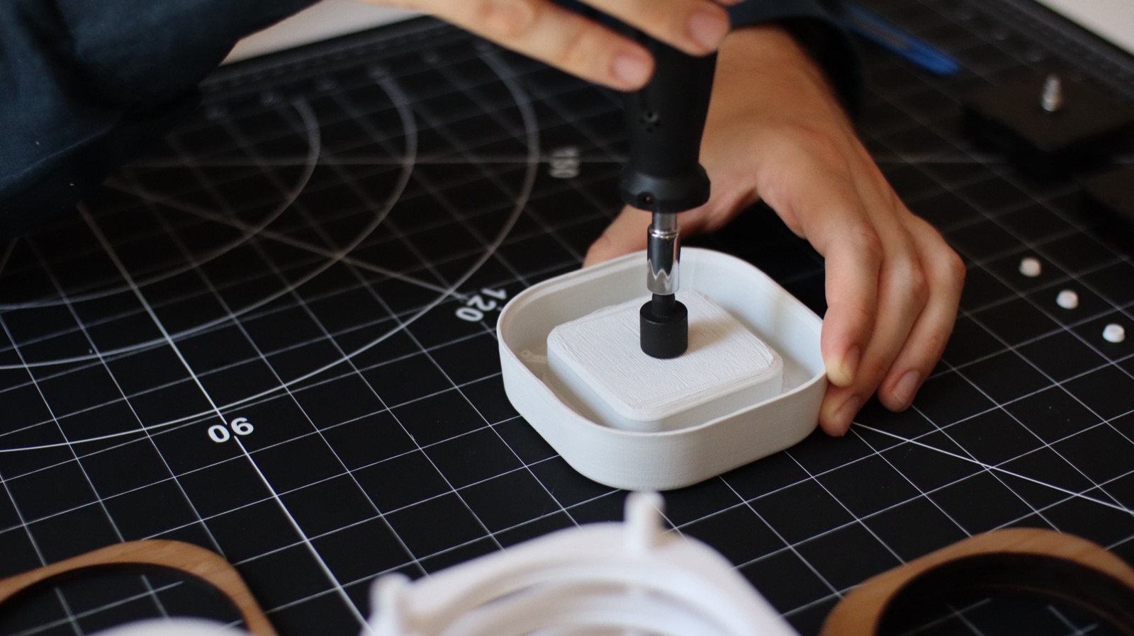 Hands working on a product prototype